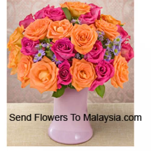 12 Pink And 12 Orange Roses With Seasonal Fillers In A Glass Vase